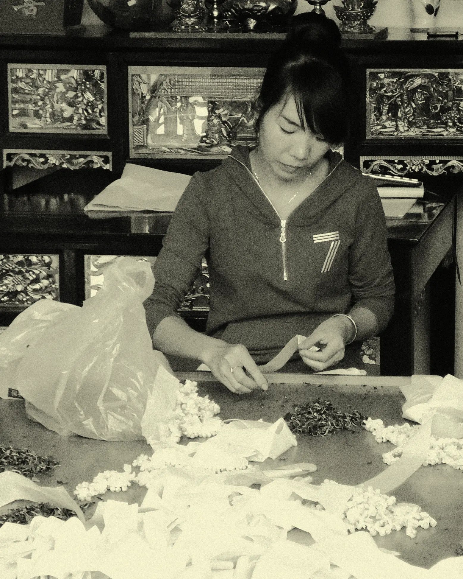 Young Woman Rolling Canton Jasmine Pearls Tea Leaves into Buds