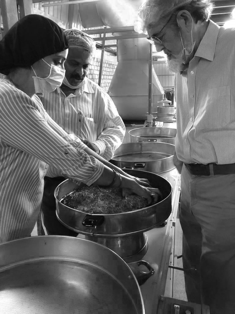 Muskan Khanna in the tea making process with two men.