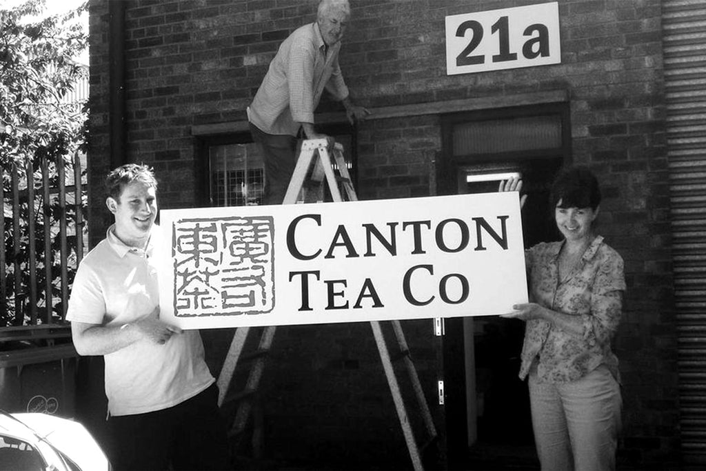 Co-founders Jen and Edgar putting up original Canton Tea Company sign