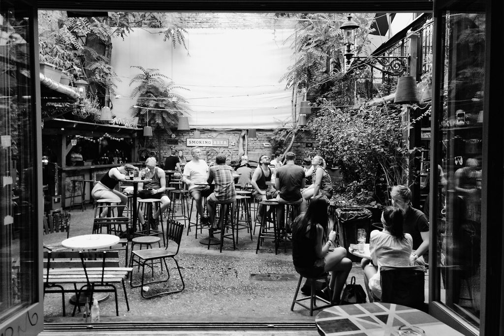 Friends eating and drinking in outdoor bar