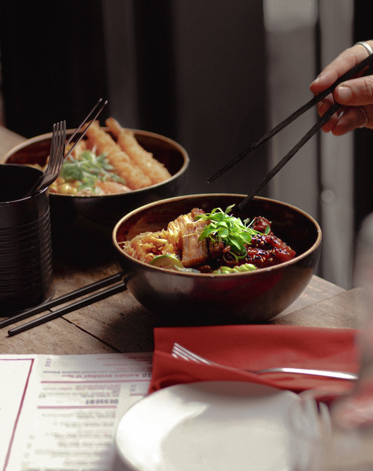 person eating food with chopsticks