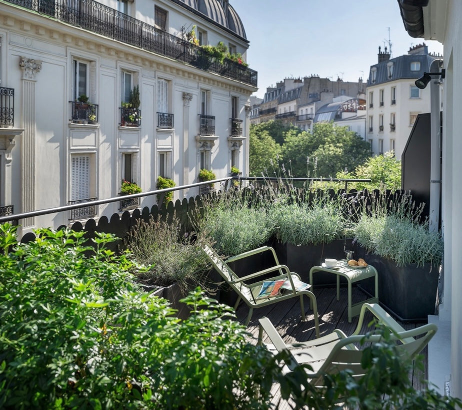 Blooming balcony oasis with vibrant plants and cozy seating, a serene escape in the heart of the city