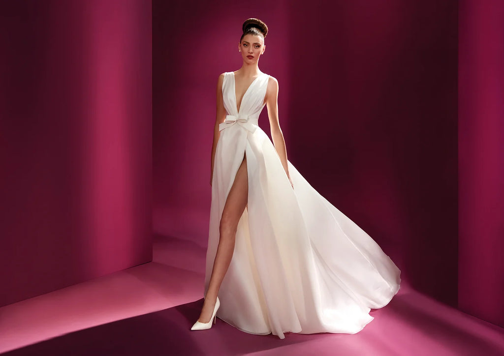 Bride in an elegant wedding dress from Pronovias with a bow and slit