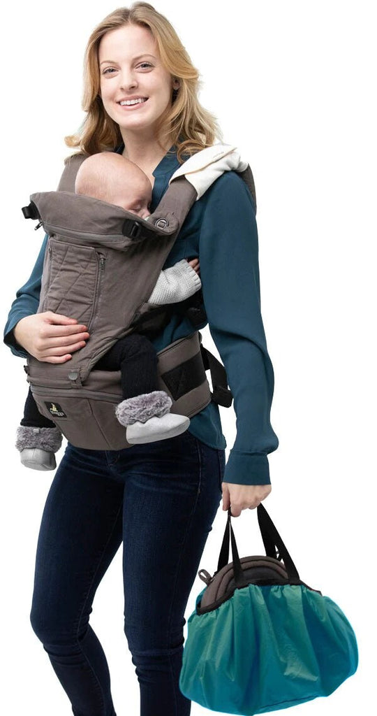 woman carrying baby on her front while carrying bag