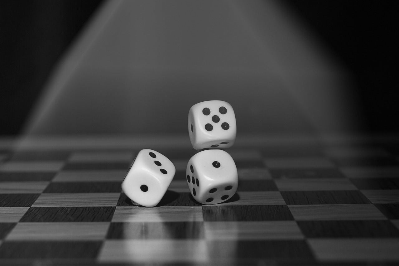 three dice on a black and white surface