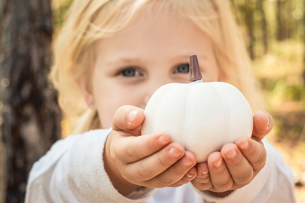 girl holding a white pumpkin