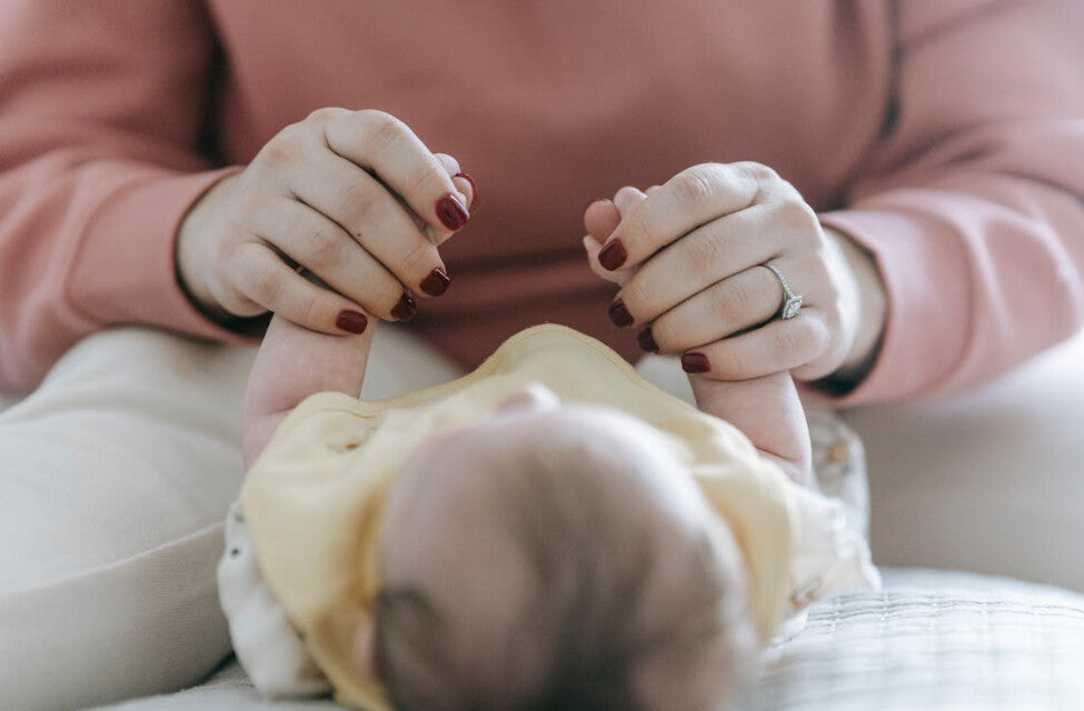 Mother giving baby massage