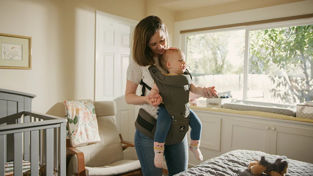 woman carrying baby on her front side