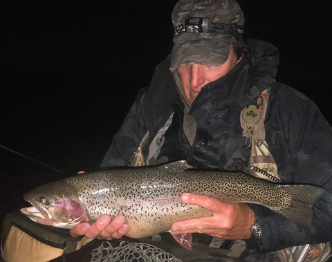 Paul holds a rainbow trout before releasing it back into the lake.