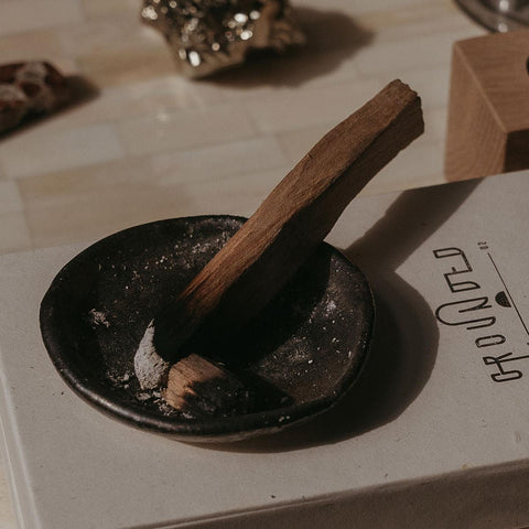 image of a palo santo stick used for aromatherapy and sold by the brand Grounded 1002