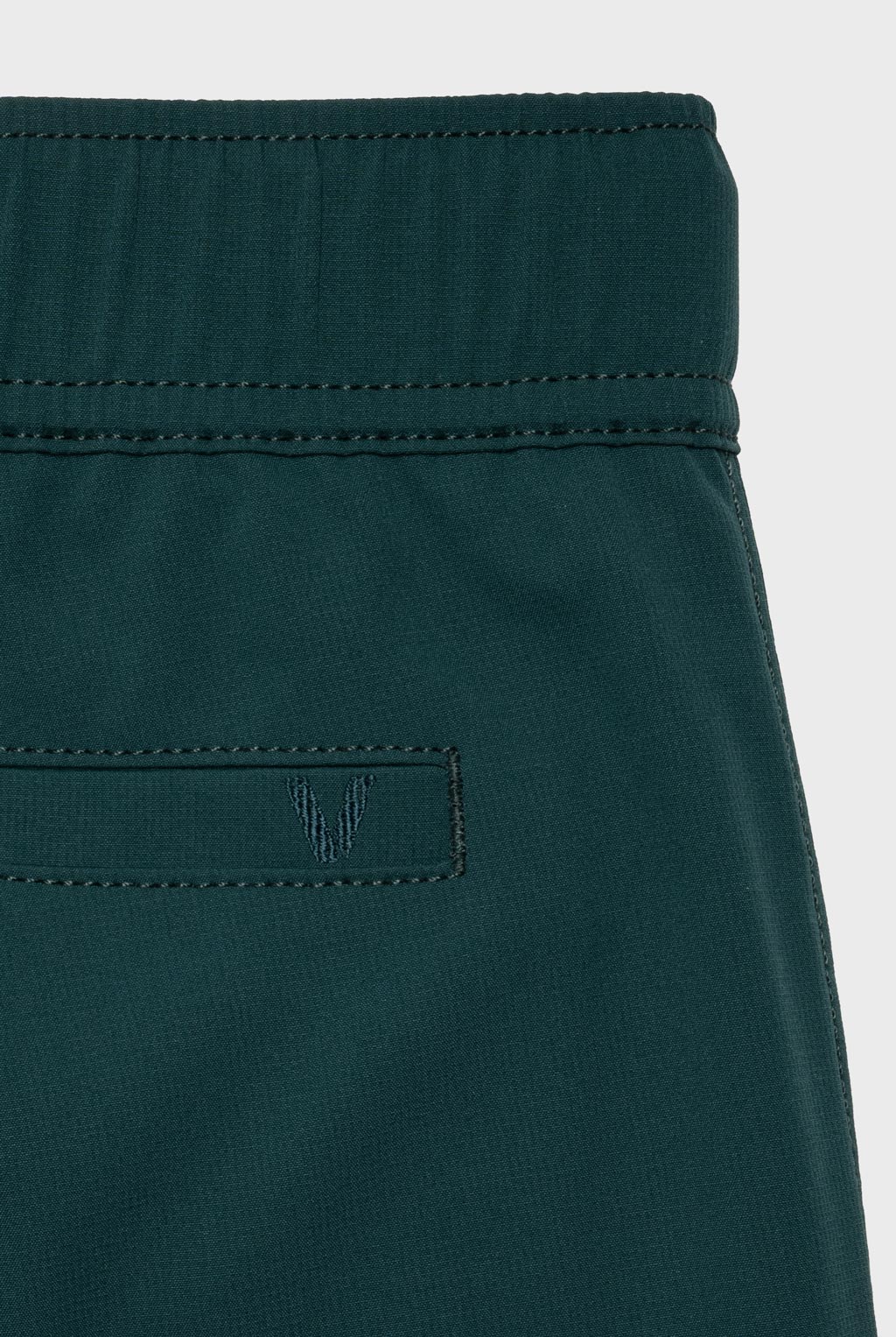 A tonal embroidered logo is visible at the back pocket.