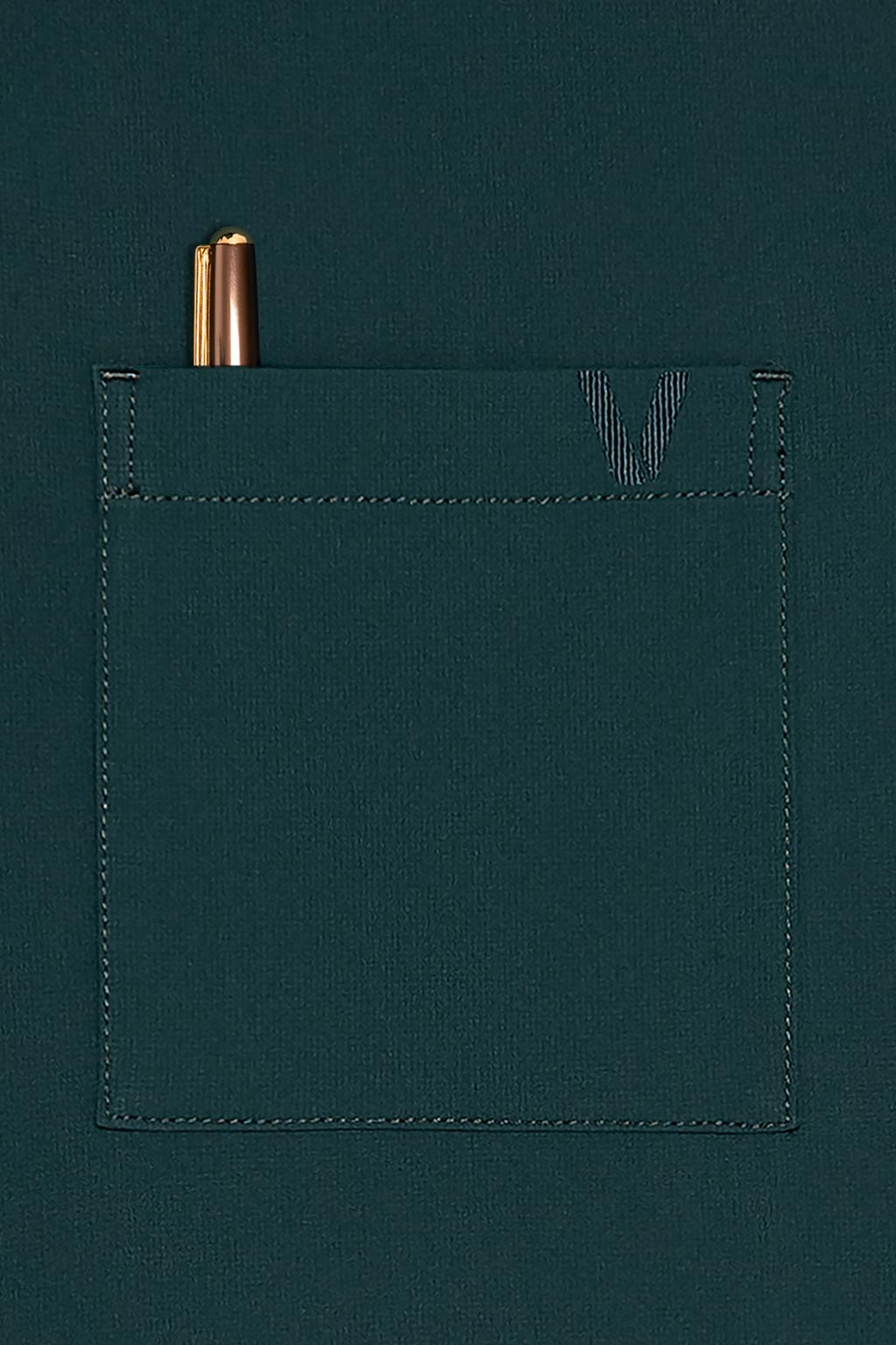 A tonal embroidered logo is visible at the chest pocket.