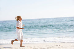femme vetu de blanc blonde 60 ans court sur la plage-blog yoga et sport bien vieillir - my shop yoga