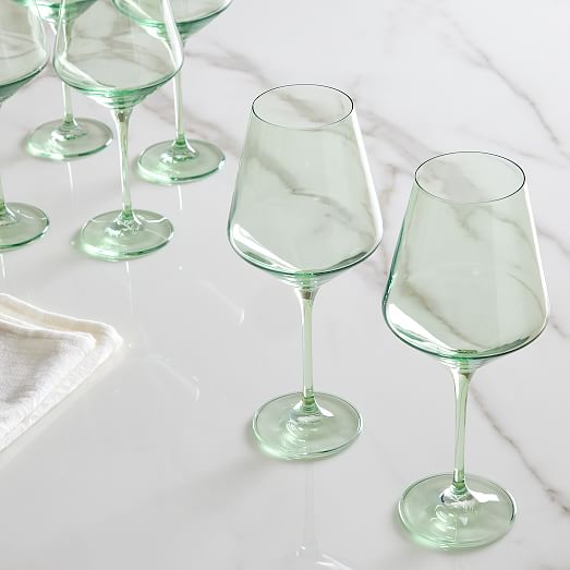 Estelle Colored Glass Stemmed Wine Glass (Set of 6) in Green on a marble table. 