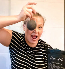 woman holding Merindah Botanicals Purifying Konjac Sponge