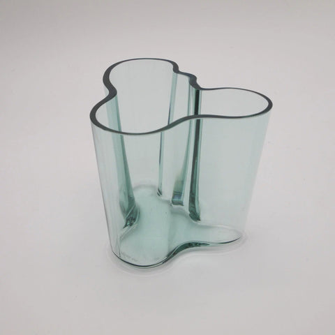 Savoy Vase by designer Alvar Aalto in Winter Green on grey background