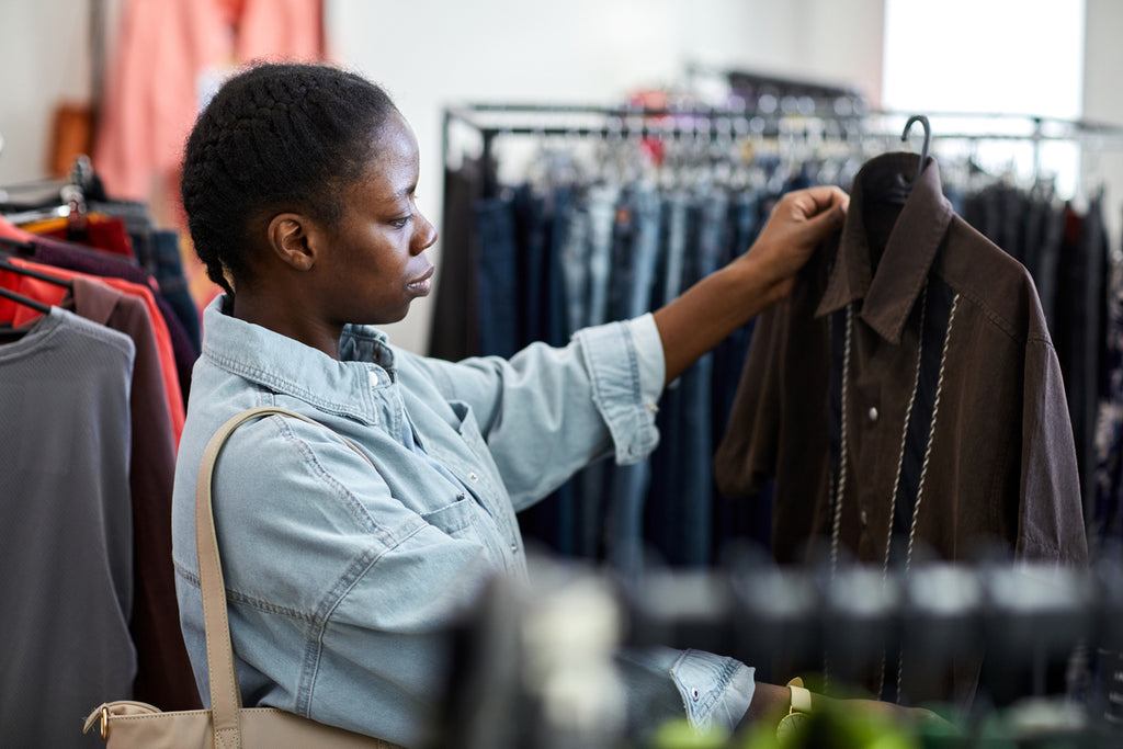 Young African American woman shopping at a thrift store