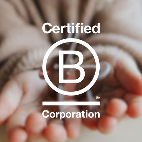 Child holding PLAYin Choc chocolate with B corporation certified logo