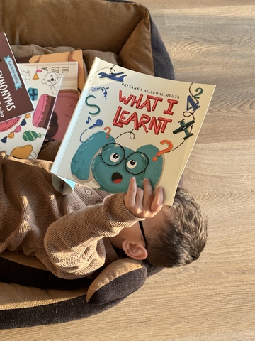 Child reading children's book on his own