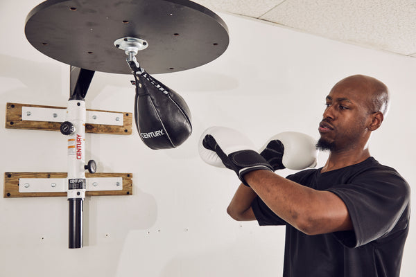 man in gloves training on speed bag