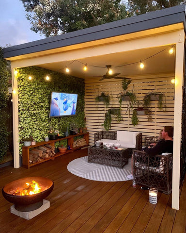 Patio with artificial green wall and hanging plants