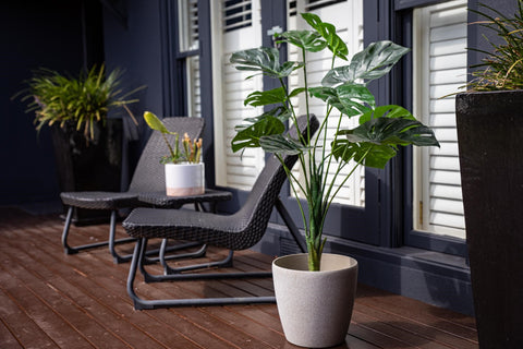 artificial plant in pot on outdoor decking