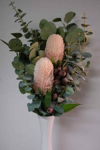 artificial floral stems in white vase