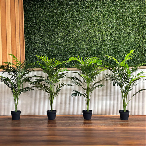 Potted artificial plant palm trees styled on wooden floor