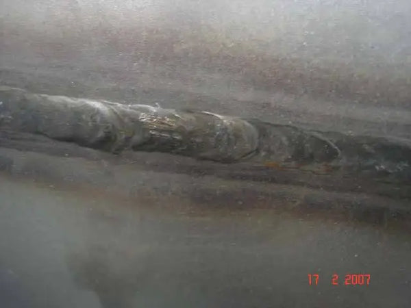 Oxidized weld due to lack of inert gas shielding.