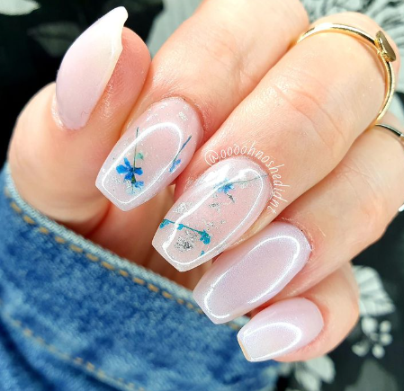 Glazed donut nails with tiny blue flowers 