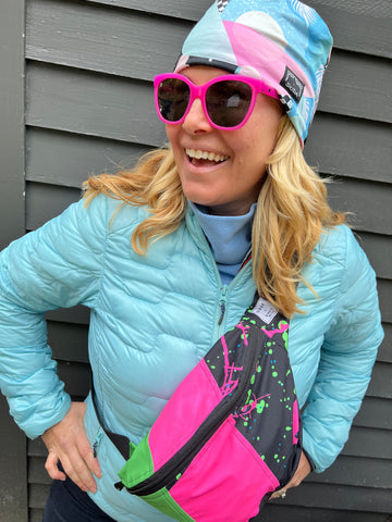 Woman smiling with bright colors upcycled fanny pack