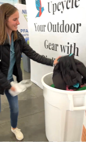 woman donating old winter clothes