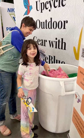 Mother and Daughter donating old winter clothing