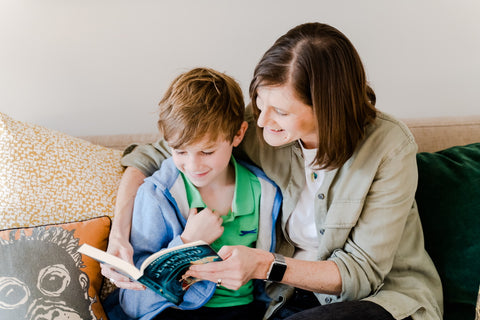 Parent and child reading Parrot Street book