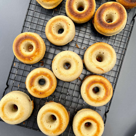 Cooked doughnuts cooling on a rack