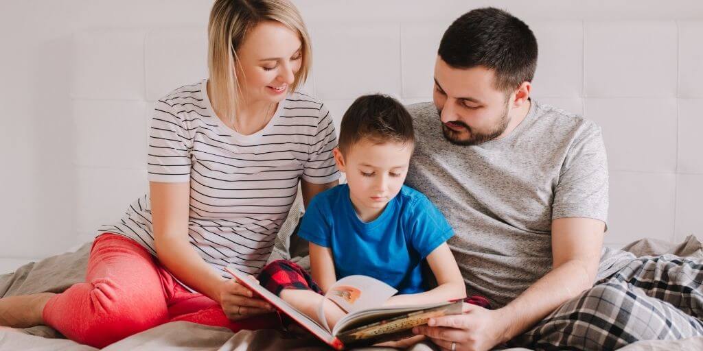 Mother and father reading with a child