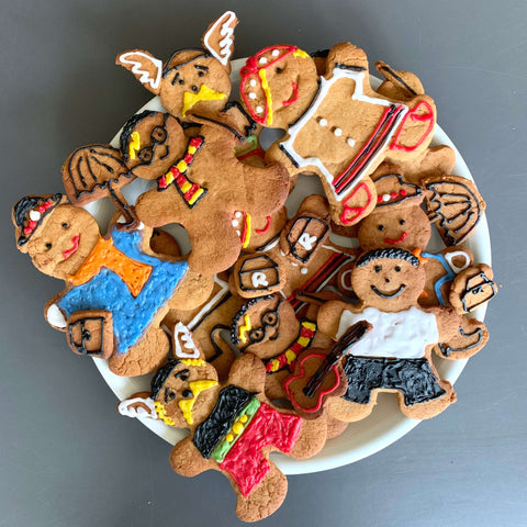 Plate of gingerbread cookies decorated like book day characters