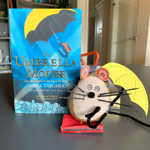 A potato decorated as The Umbrella Mouse next to the book The Umbrella Mouse