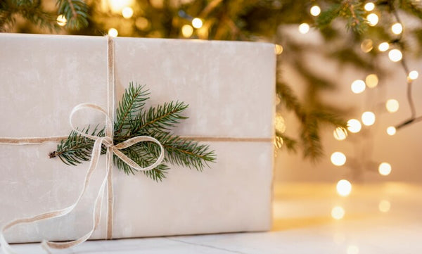 Wrapped book gift under a Christmas tree