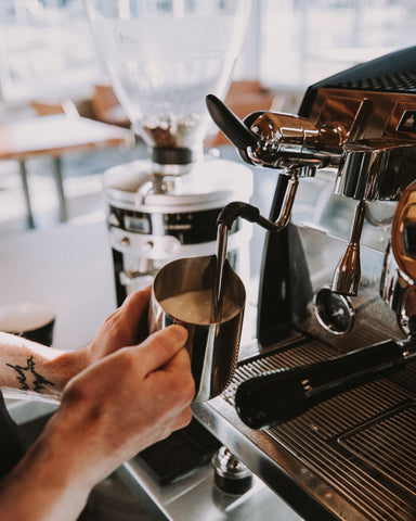 Barista Whisk Milk in Coffee Machine with Hot Steam, People Stock