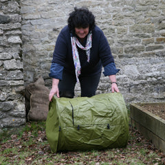 Gardening expert Pippa Greenwood rolling a Haxnicks Rollmix composter
