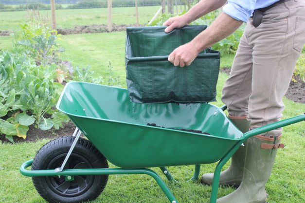 Haxnicks Easy Riddle garden sieve in use with compost over wheelbarrow