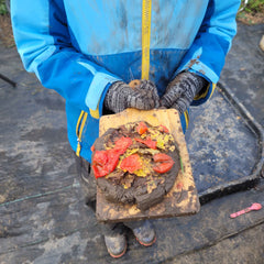 Mud-pizza-in-childs-gloved-hands