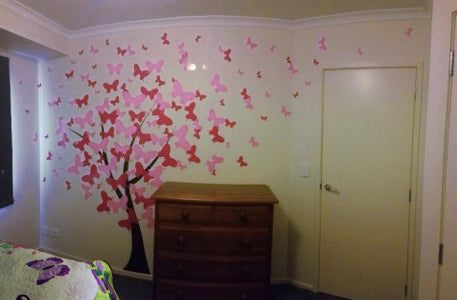 a bedroom wall of butterflies