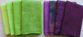 color run of fabrics in purples and greens