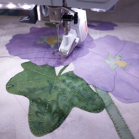 starting to stitch the hollyhock block using free motion machine stitching