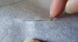 fusible webbing paper scored with a pin for easy removable