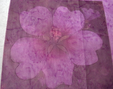 Outline of flower drawn on pink fabric using a lightbox