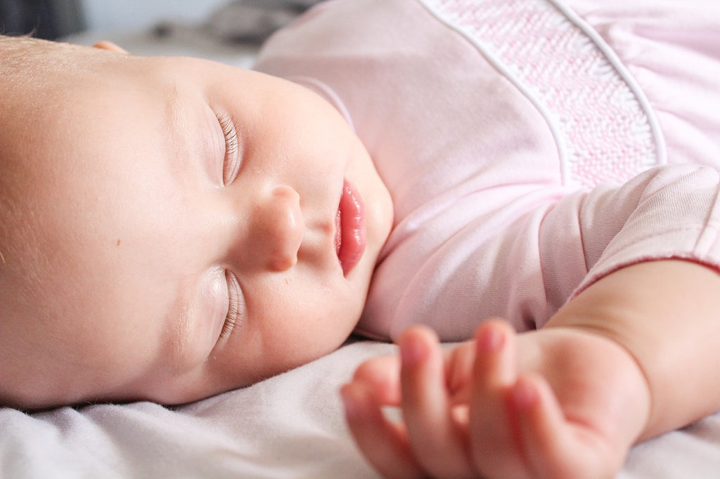 baby asleep in its crib