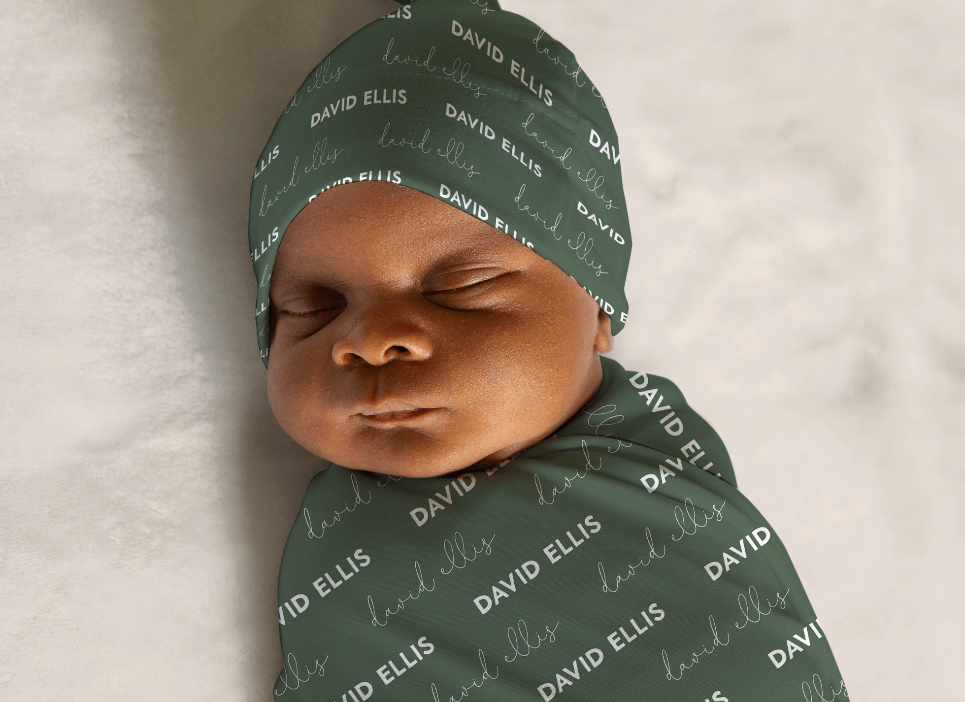 baby boy wrapped in baby name swaddle